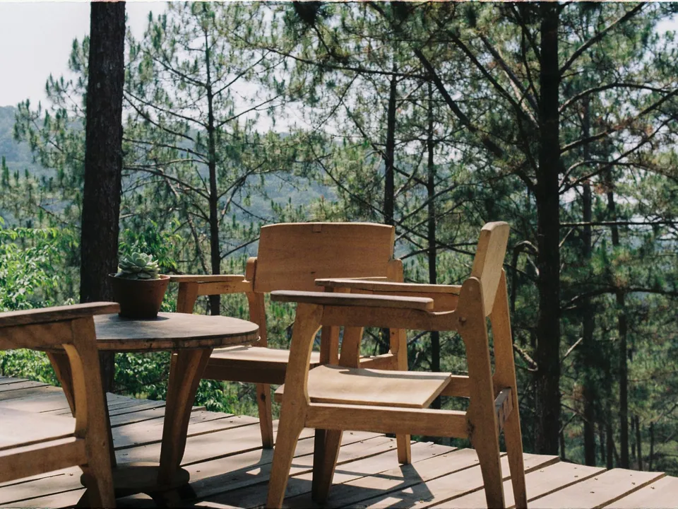 Wooden deck with outdoor seating and a forest view