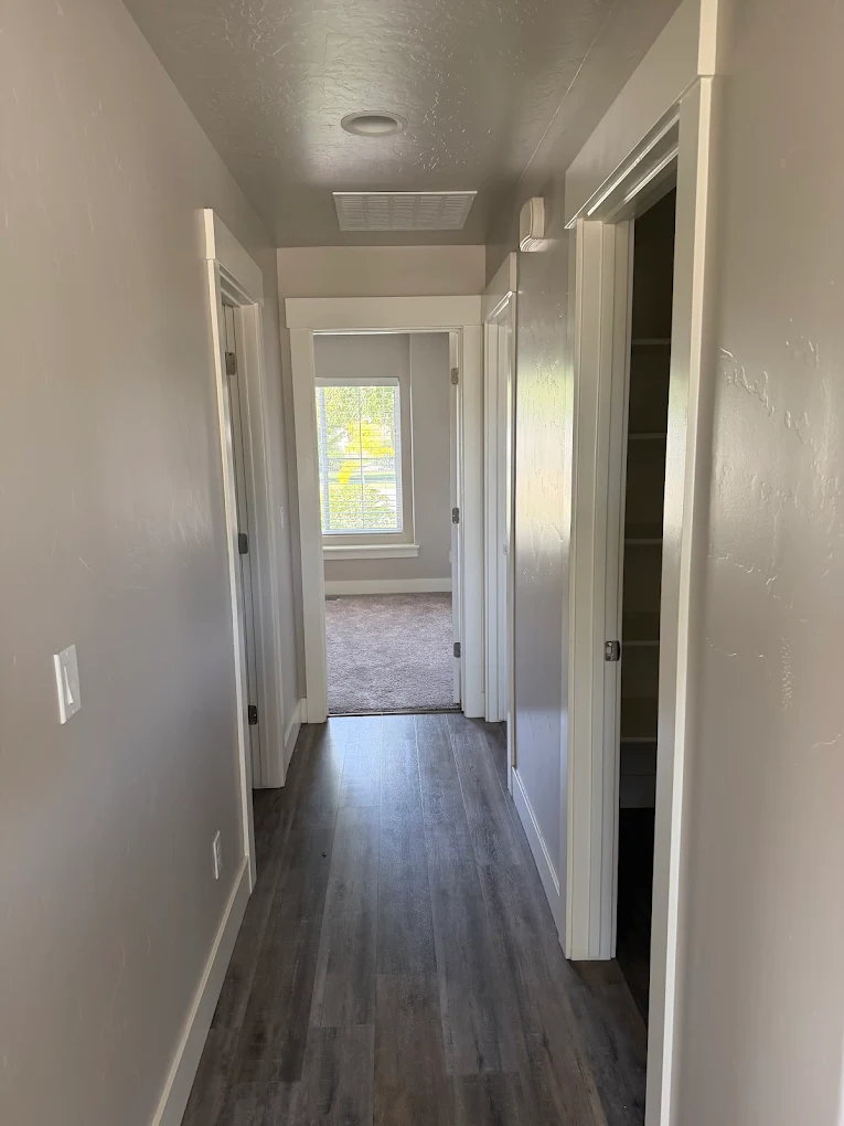 Interior hallway painting with crisp white trim in a Boise, Idaho home