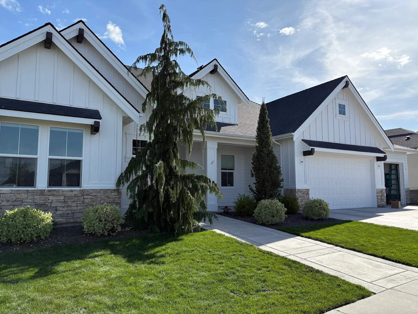 Exterior painting of a white farmhouse in Meridian, Idaho